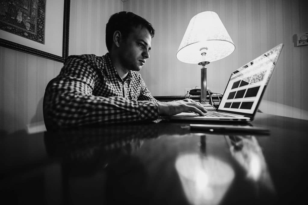 frustrated young business man working on laptop computer at offi